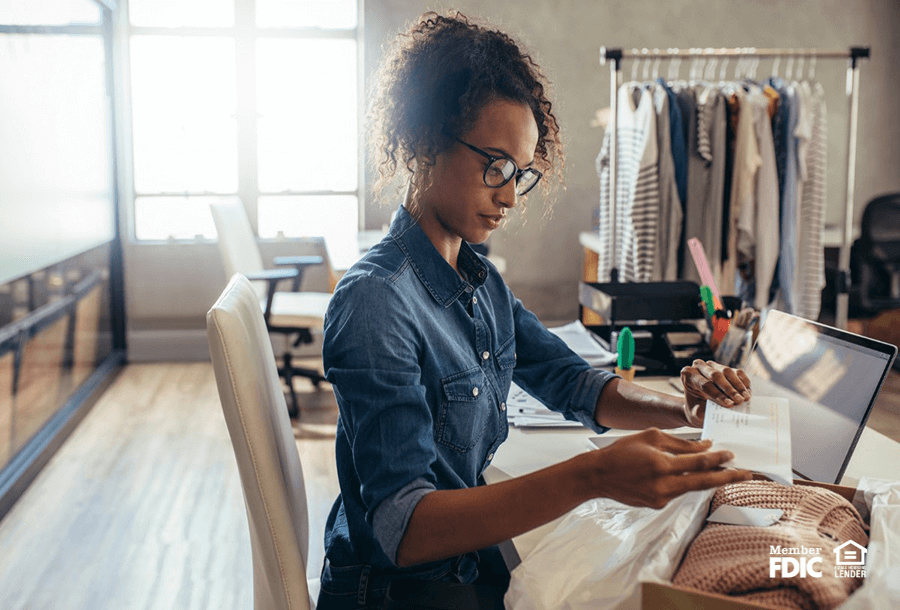 a business woman prepares a product for shipping from her small business