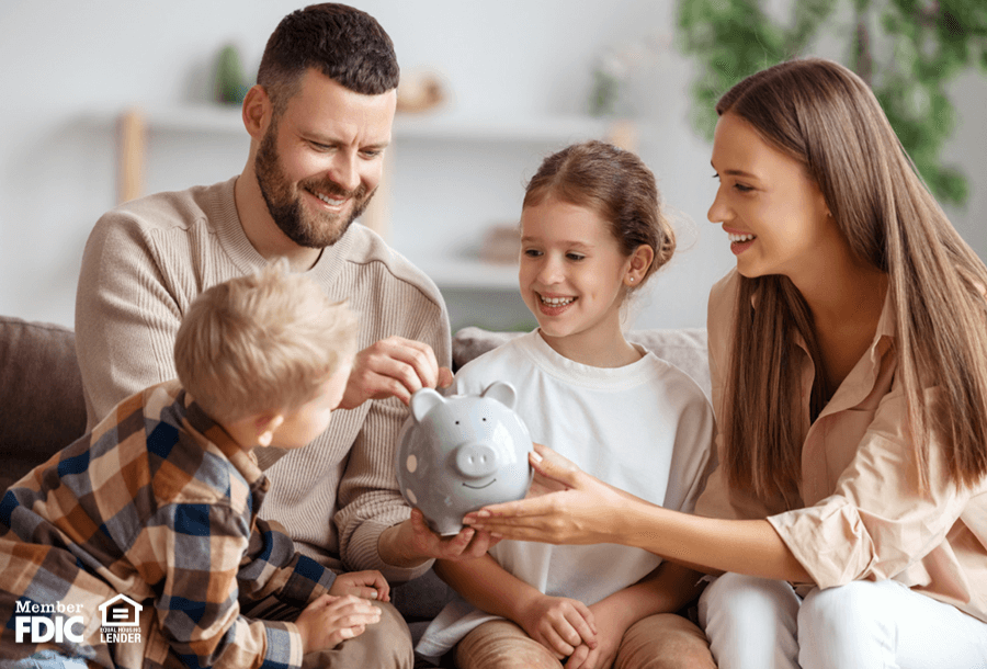 two parents show their kids how important saving is with a piggy bank
