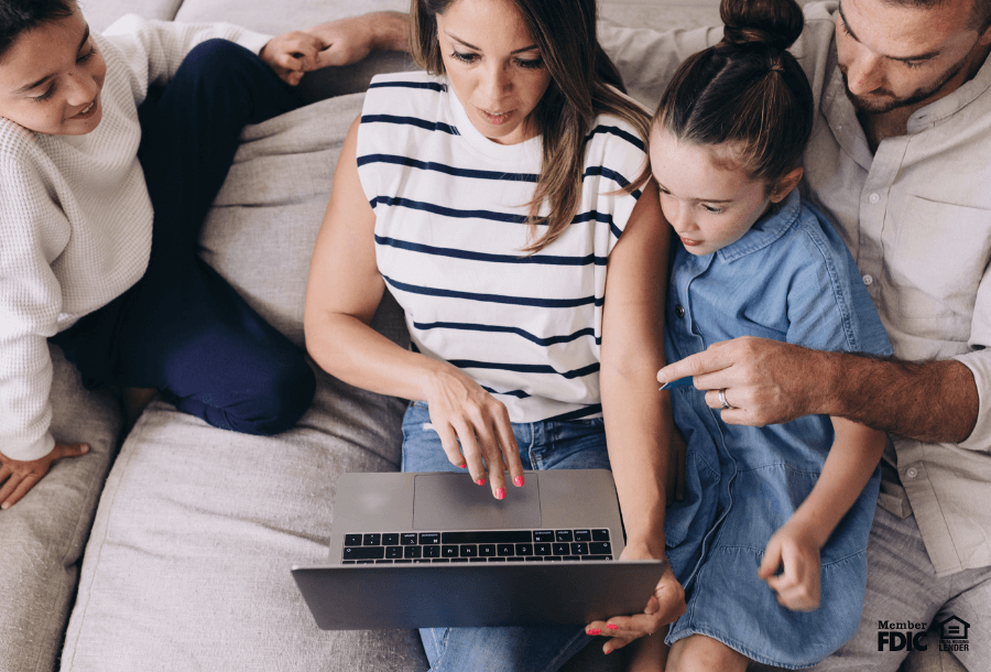 a family looks at the family budget together online