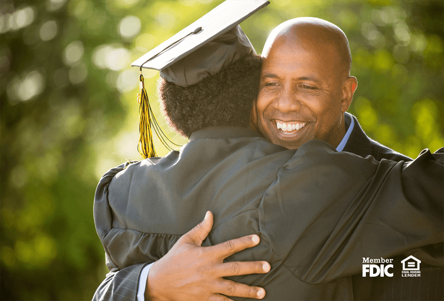 a man hugs a high school or college graduate after telling him about his financial gift