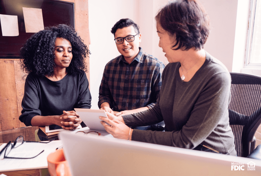 a woman works with a couple on their taxes