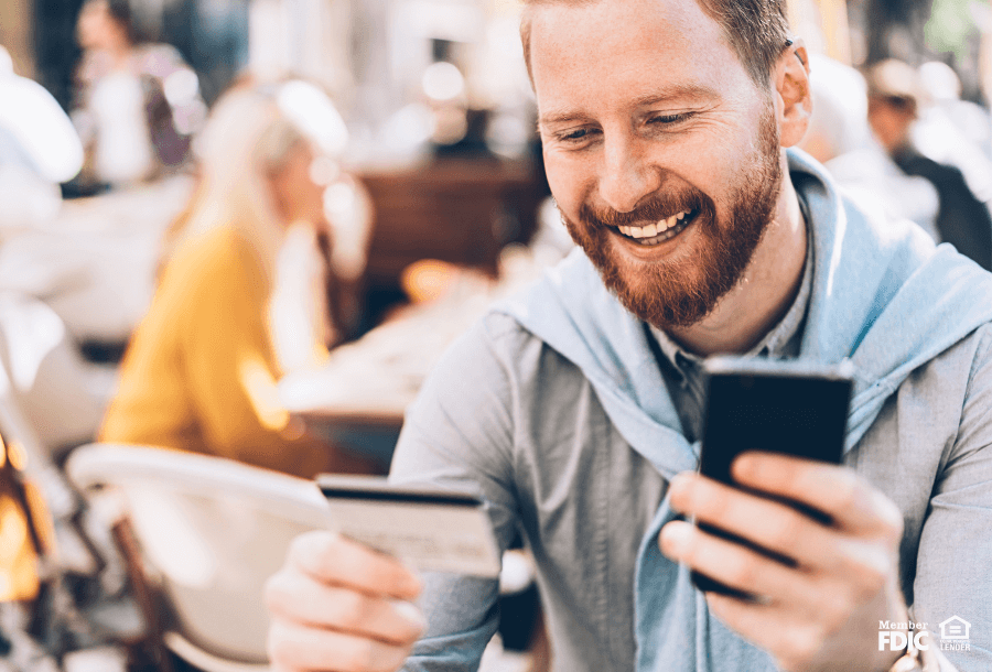 a man confirming a credit card purchase through online banking