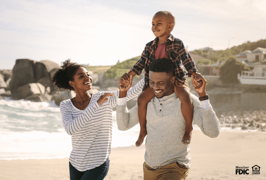 a family laughing on a beach enjoying vacation