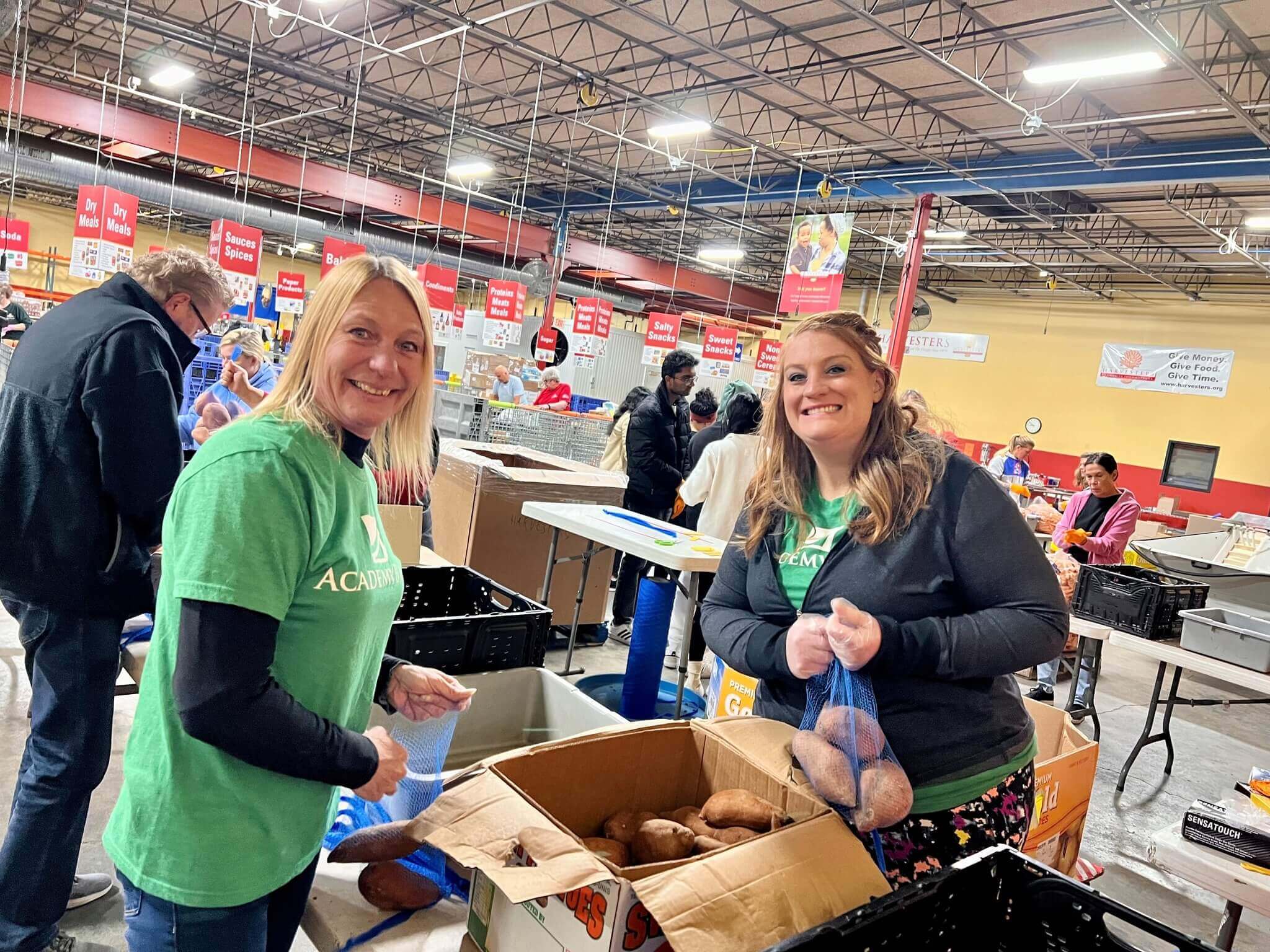 Academy Bank employees pack food boxes for days of giving charity work