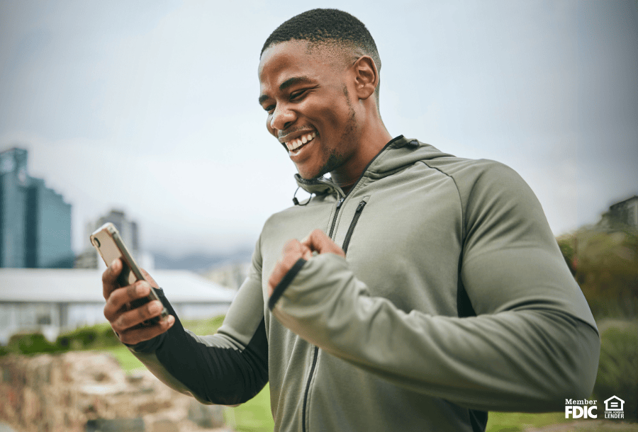 Smiling man who feels safe knowing that his checking account is FDIC-insured.