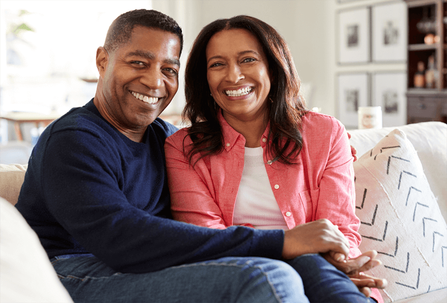 a happy couple talk about their retirement funding and IRA account