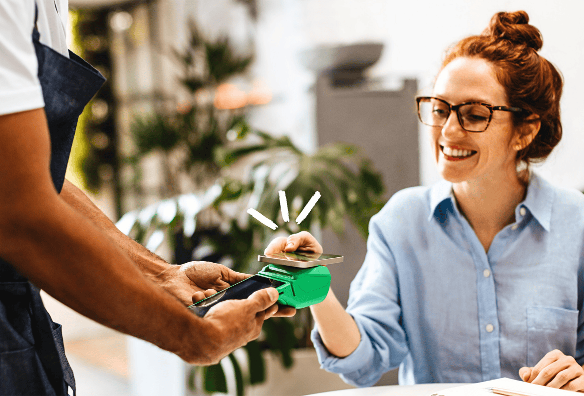 Woman uses her mobile digital wallet to pay for a lunch.