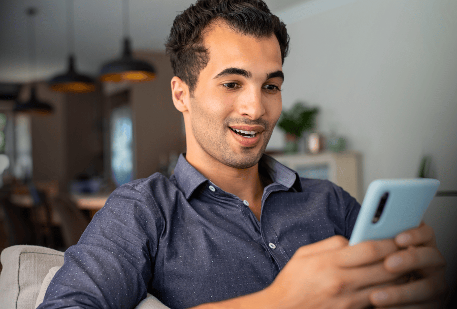 Man using his smartphone to protect himself against payday loan scams.