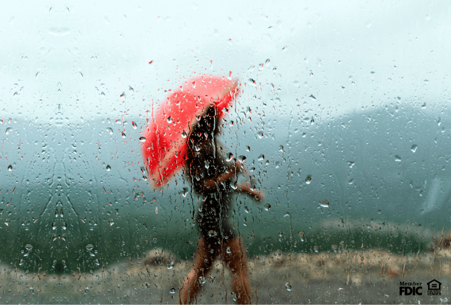 a person walks around outside on a rainy day with a red umbrella