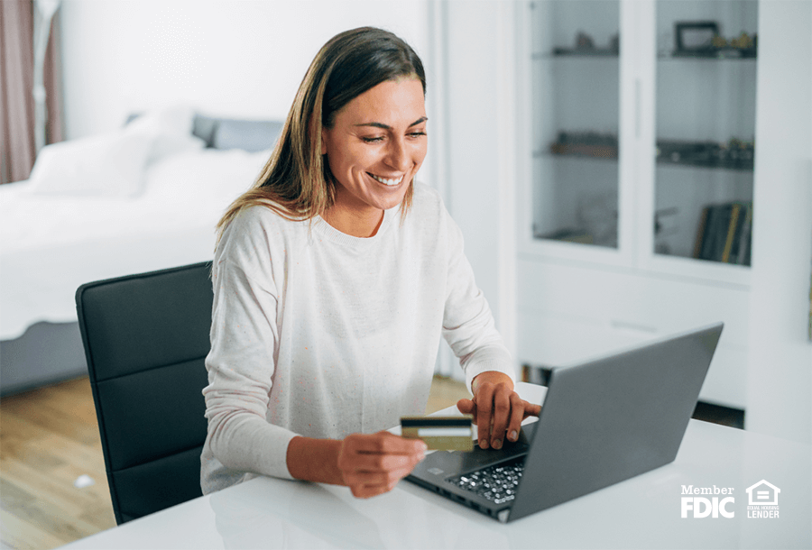 a woman smiles while learning about all of the rewards available with a select rewards checking account.