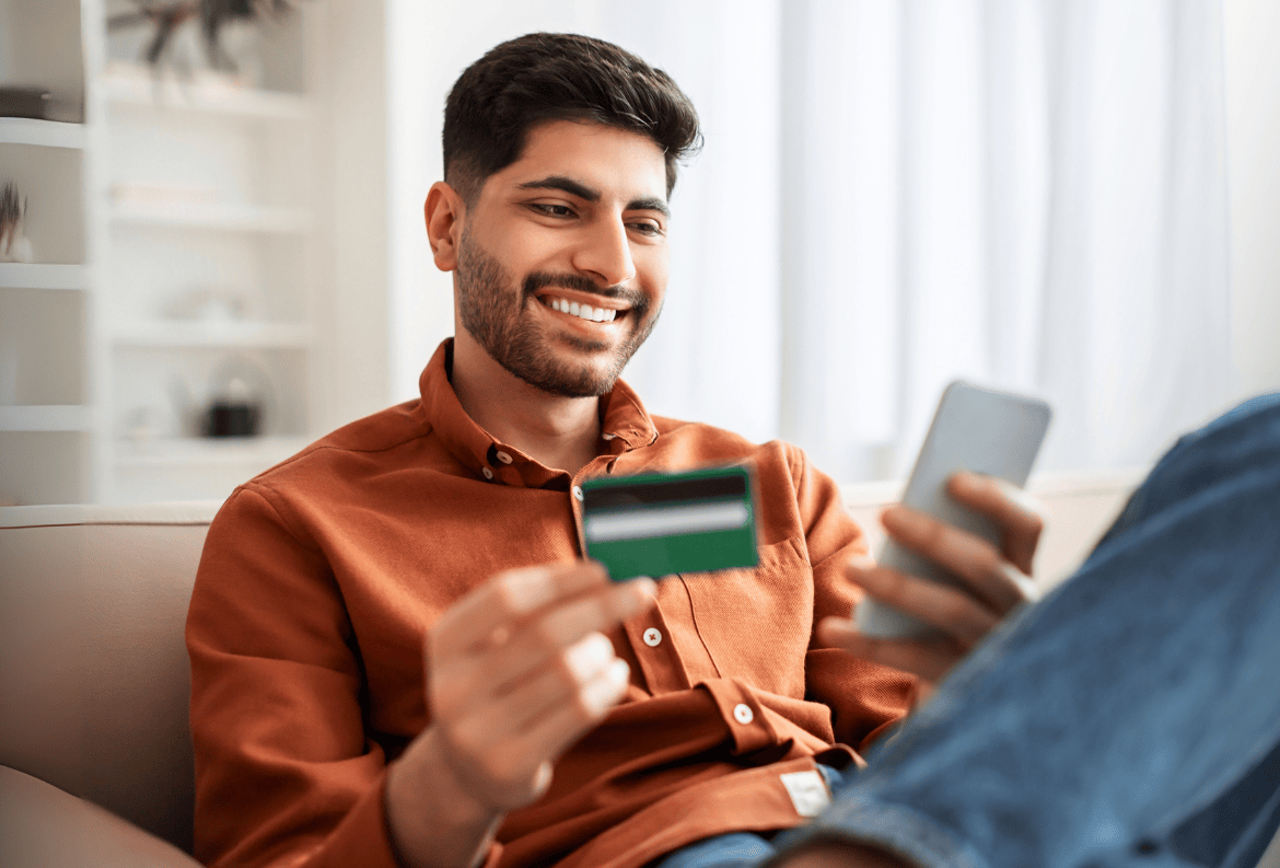 Man using a debit card from his money market account to make a large purchase