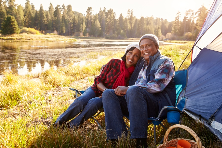 couple enjoying the outdoors near their campsite