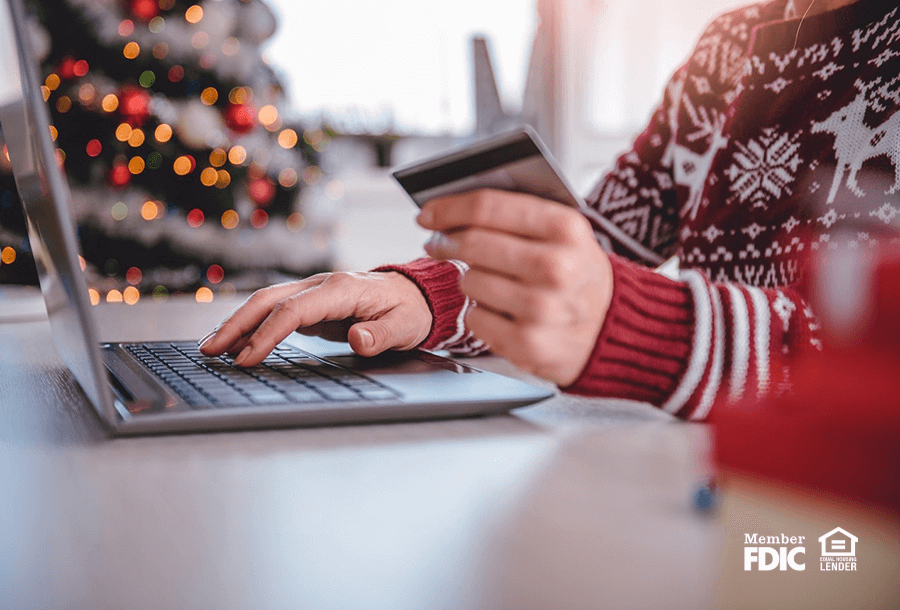 a person checks their credit card usage during the holidays so they don't build up debt