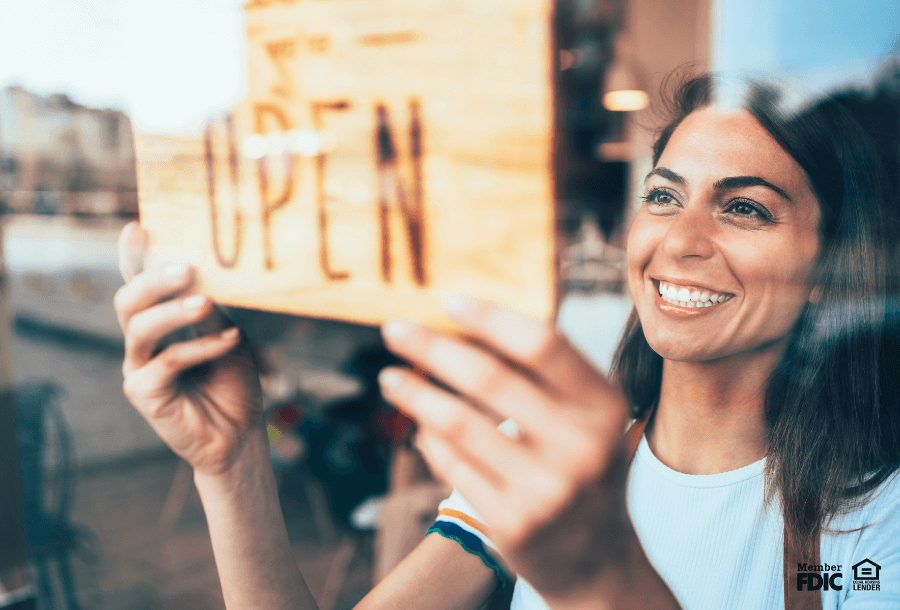 a small business owner opens their shop fror business