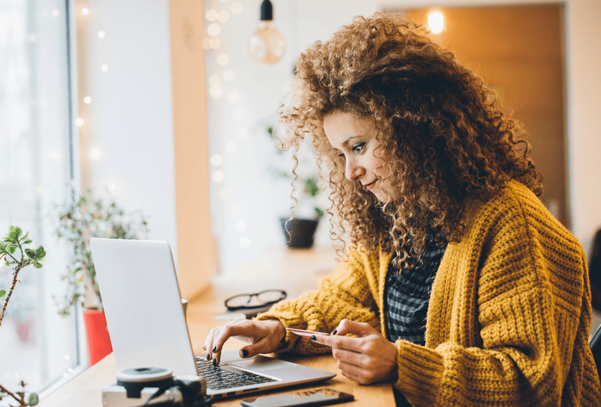 Young woman plans her finances for holiday shopping.