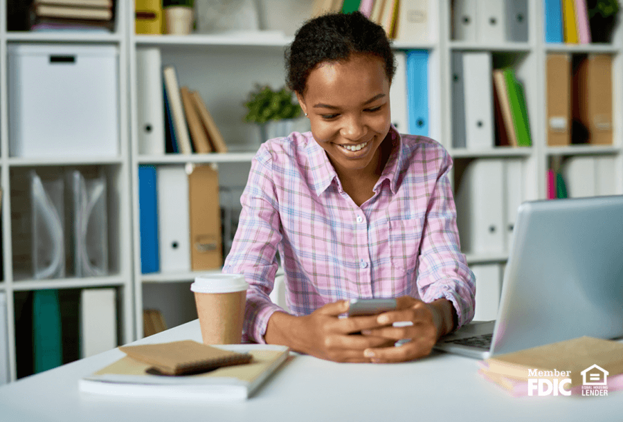 a woman happily reads up on her digital banking security features