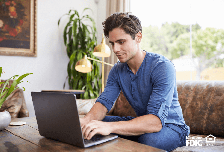 a man checks his online banking as a means of protecting from cybersecurity