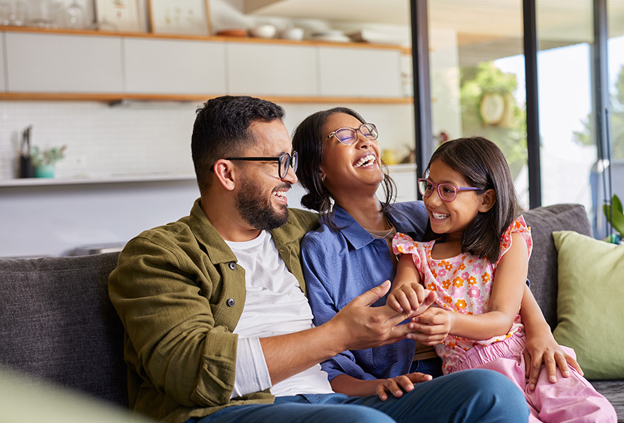 mother and father enjoying time with their daughter