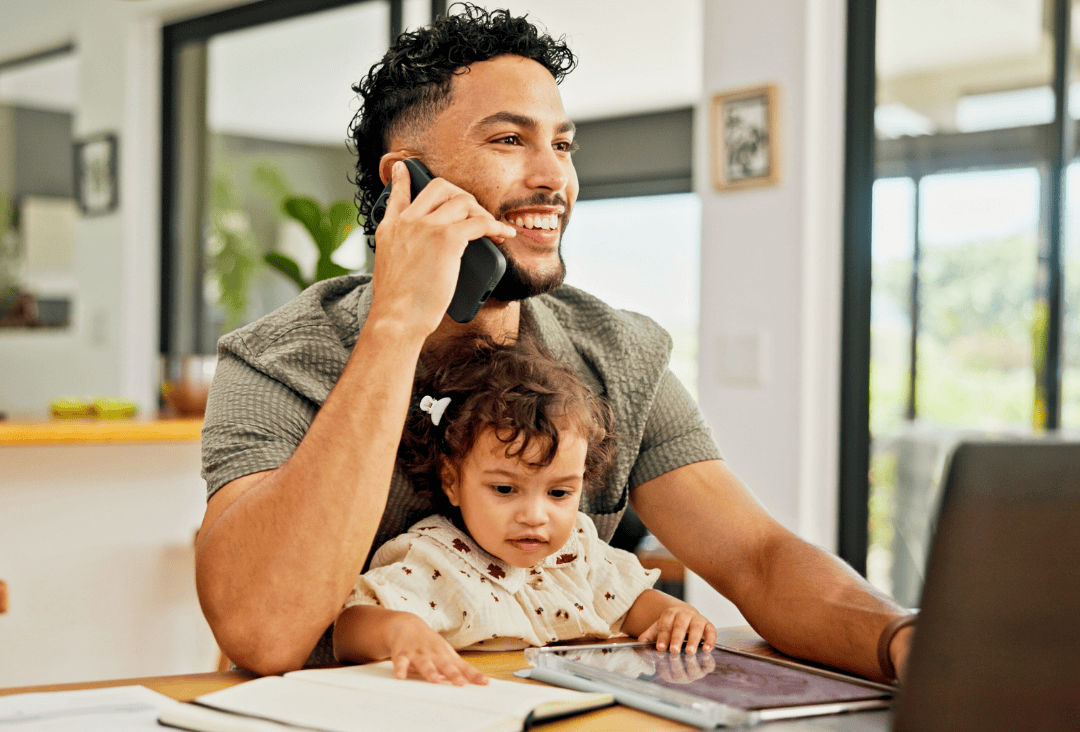 Father with baby, planning tax refund for emergency savings fund.