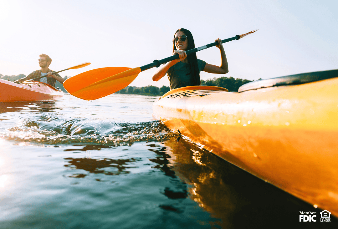 People kayaking on a lake during a bank holiday in 2026.
