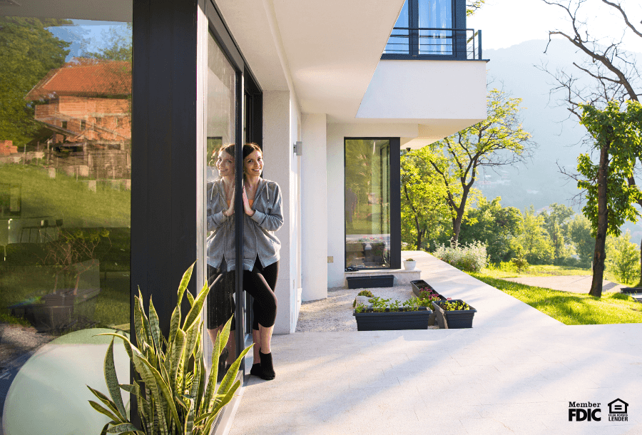 a young woman poses with her newly purchased home