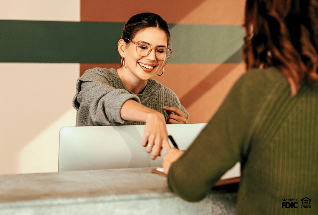Personal banker helping client at Academy Bank in Walmart.