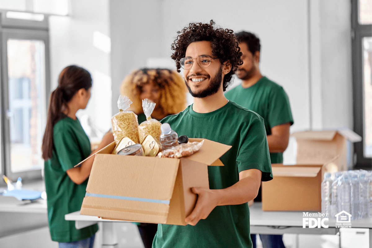 a group of individuals pack up donated food for Days of Giving