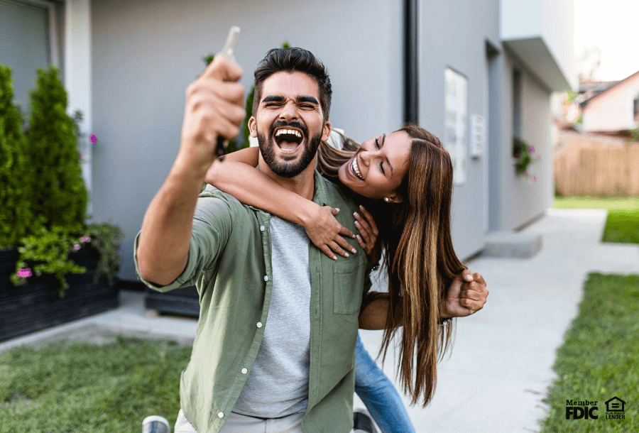 A couple celebrates the purchase of their new home.