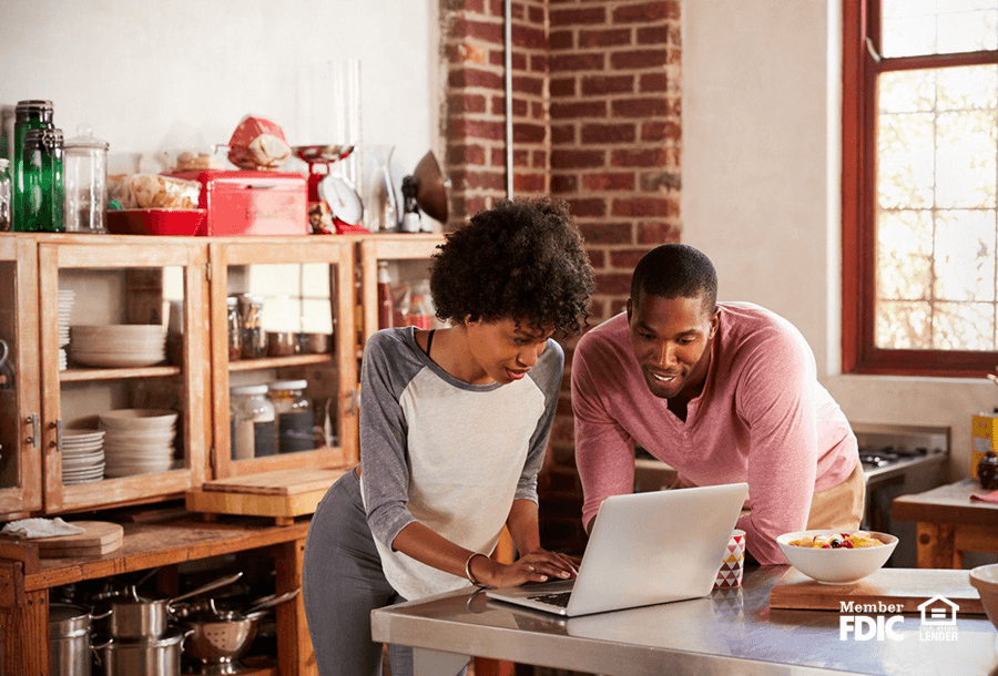 a couple looking over housing prices and loan rates