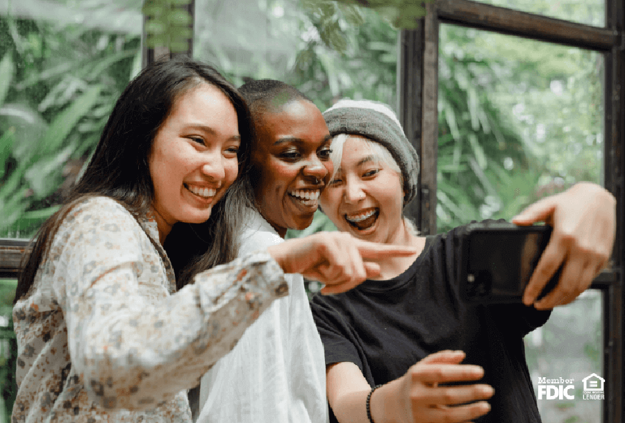 three friends take a selfi while on vacation