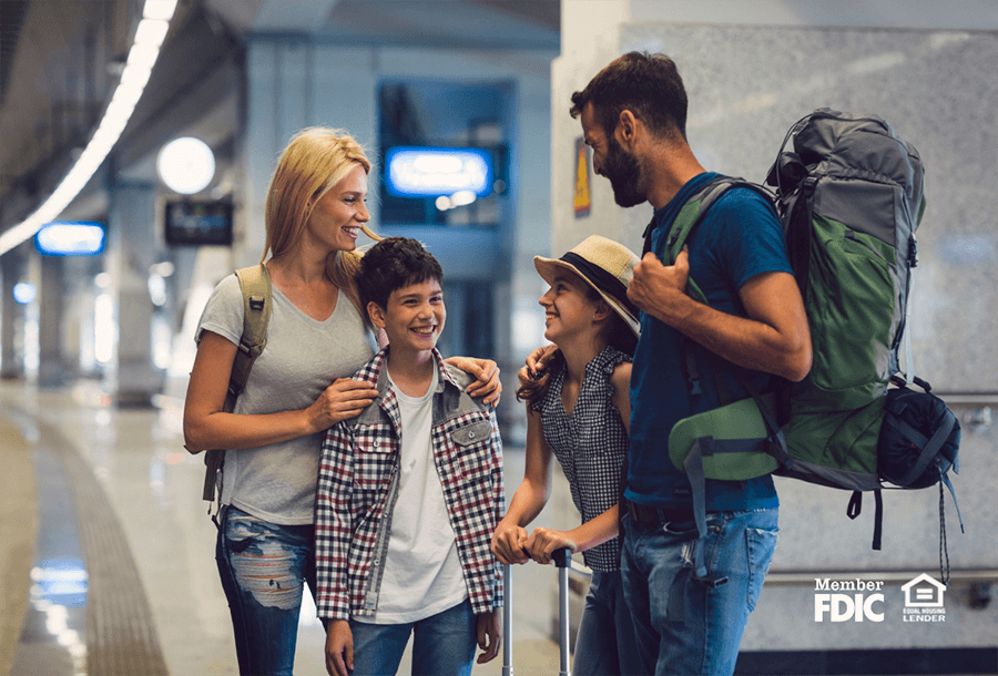 a family waits to board their plane for their summer travels