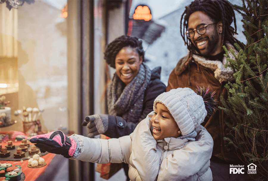 a family goes window shopping during the holiday season.