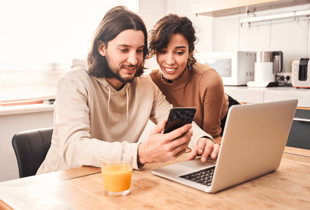 Couple reviewing personal loan refinance rates online.