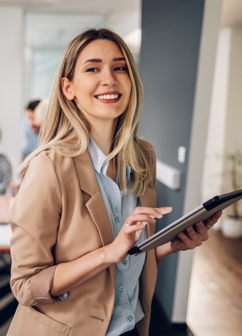 a business woman works on a project on her tablet