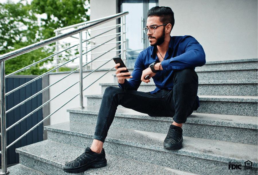 a man check's his emergency fund's balance using mobile banking