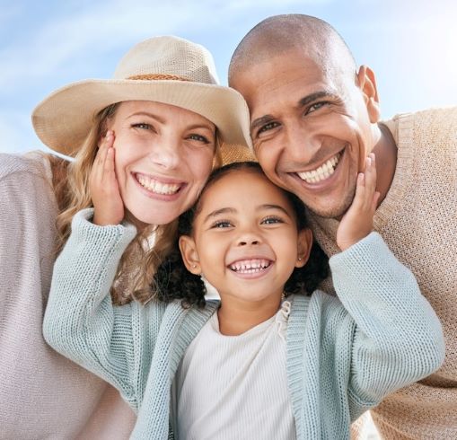 a multiracial family poses for a photo