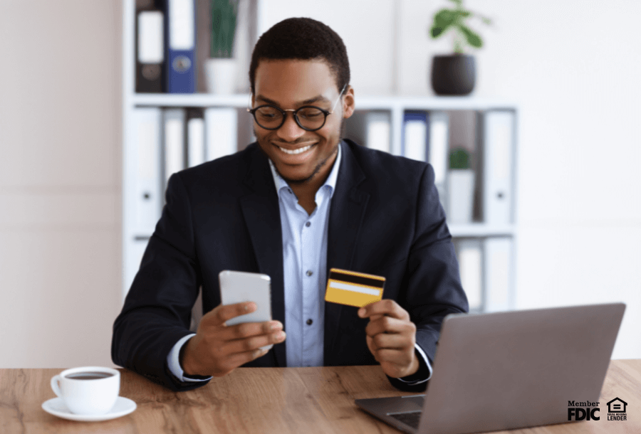 a young man checks his checking account through the mobile banking app