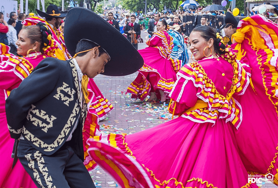 traditionally dressed Hispanic dancers preform in a street parade 
