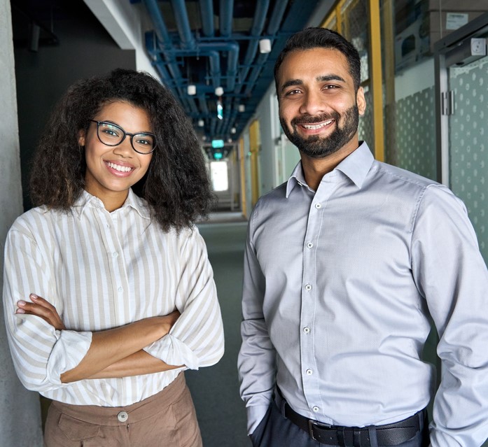 two coworkers pose together at work