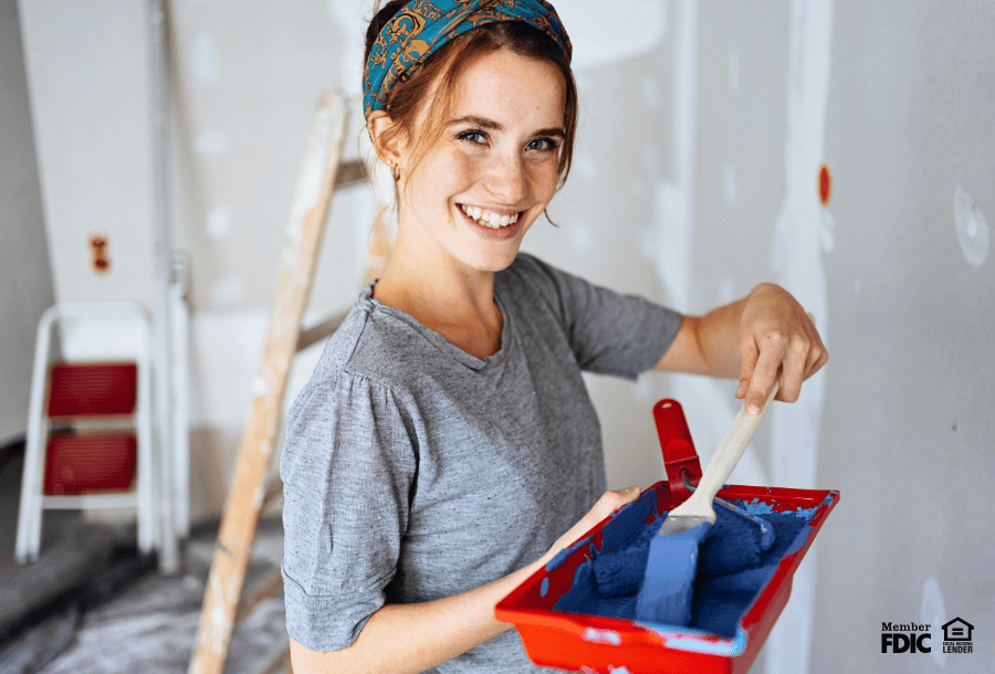 Woman working on home improvement project, thanks to meeting the HELOC eligibility requirements.