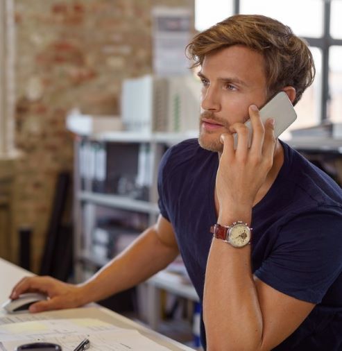 man on phone with his bank going over new checking account options. 