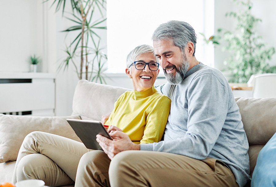 a couple goes over their retirement funding together through online banking