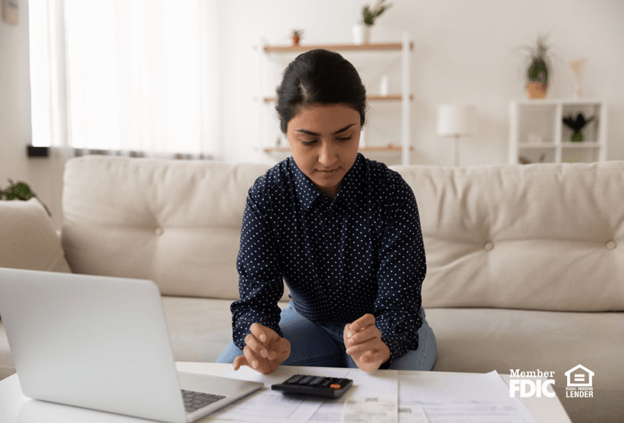 a woman preforms her mid-year financial check of her accounts