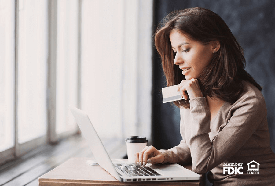 a business woman checks her banking online with her laptop