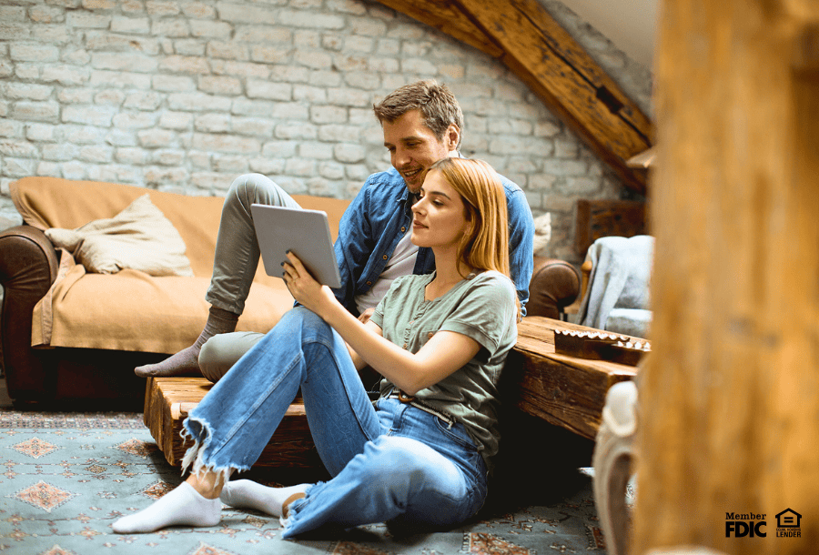 Couple at home, choosing between a HELOC or cash-out refinance.