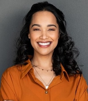 a smiling woman with black curly hair