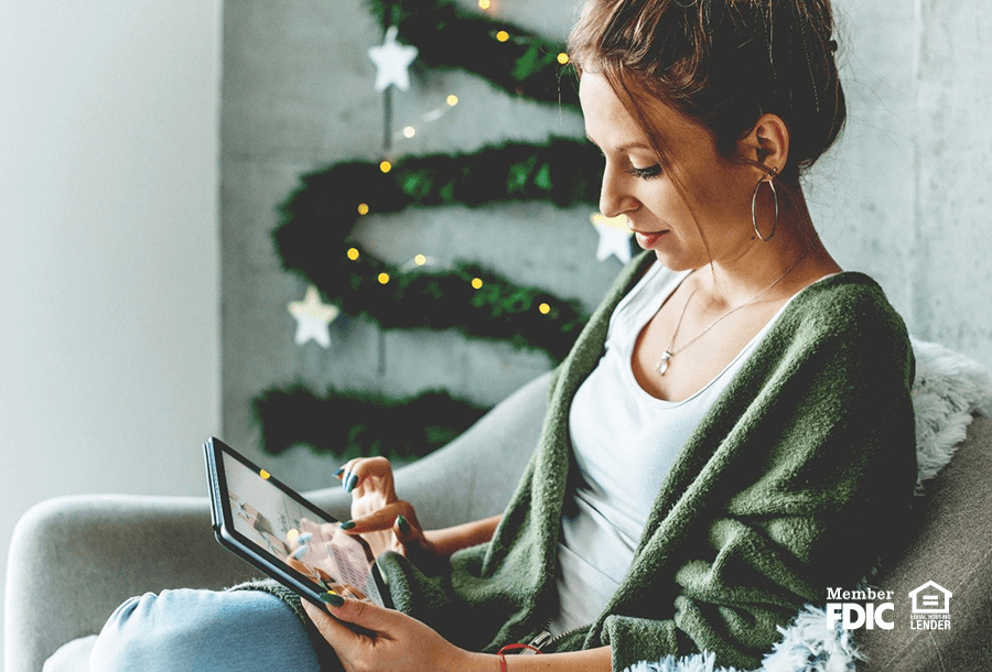 a woman checks her account statuses during the holidays with online banking