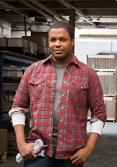 a man poses in a shipping factory