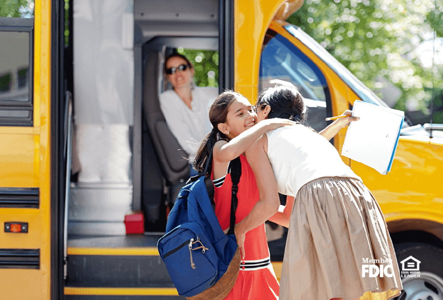 a mother hugs her daughter before sending off on her first day back to school