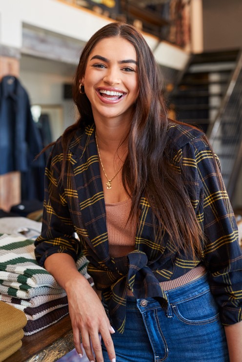 a young woman smiles a her job